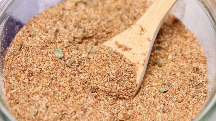 Creole seasoning in a bowl with wood spoon.