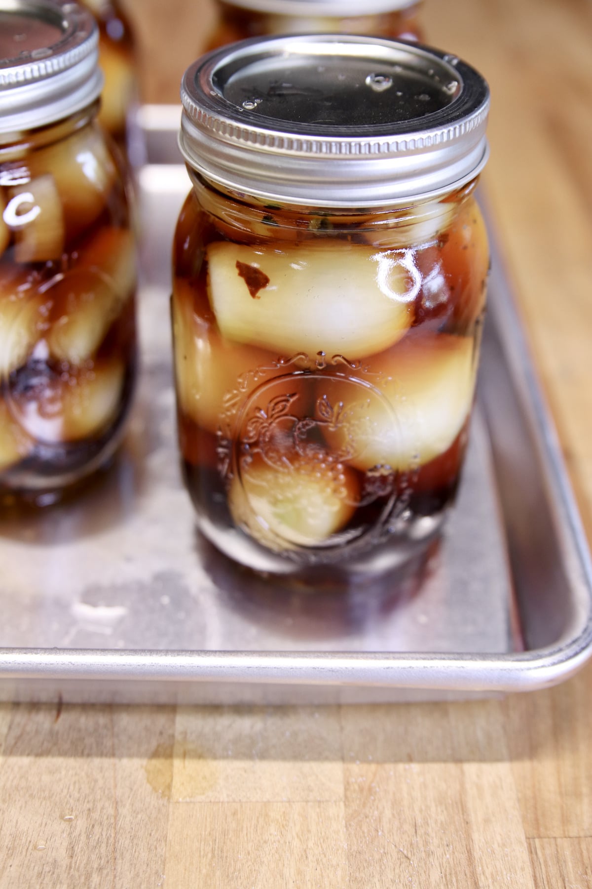 Jars of pickled onions in malt vinegar.