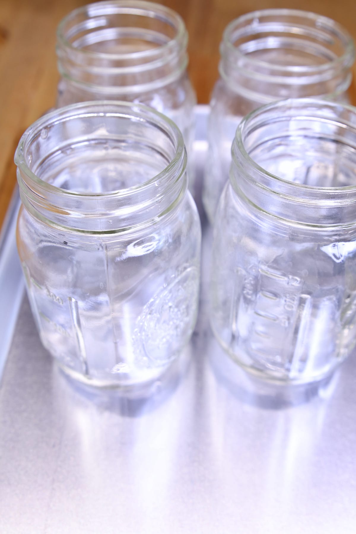 Pint jars on a baking sheet.