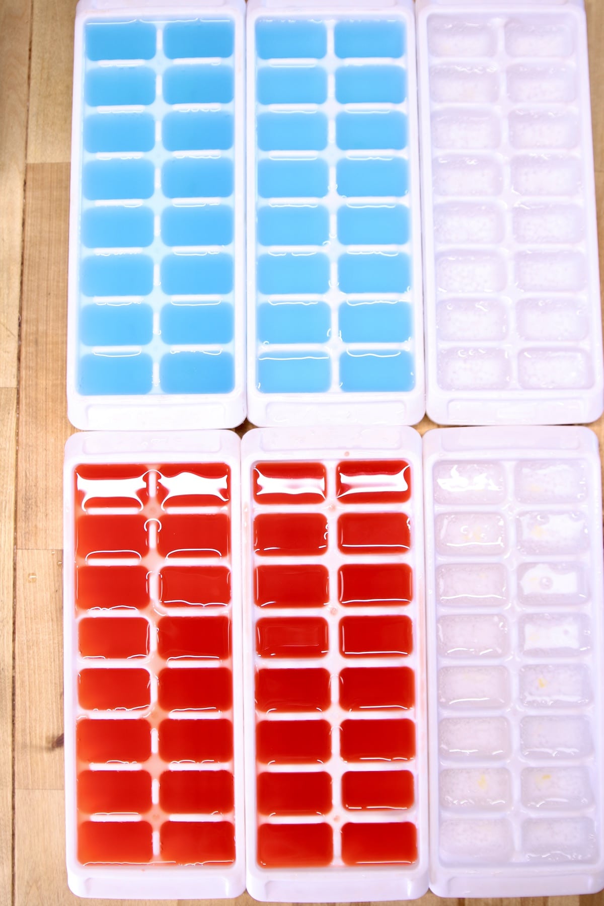 6 ice trays with red and blue punch, sprite.