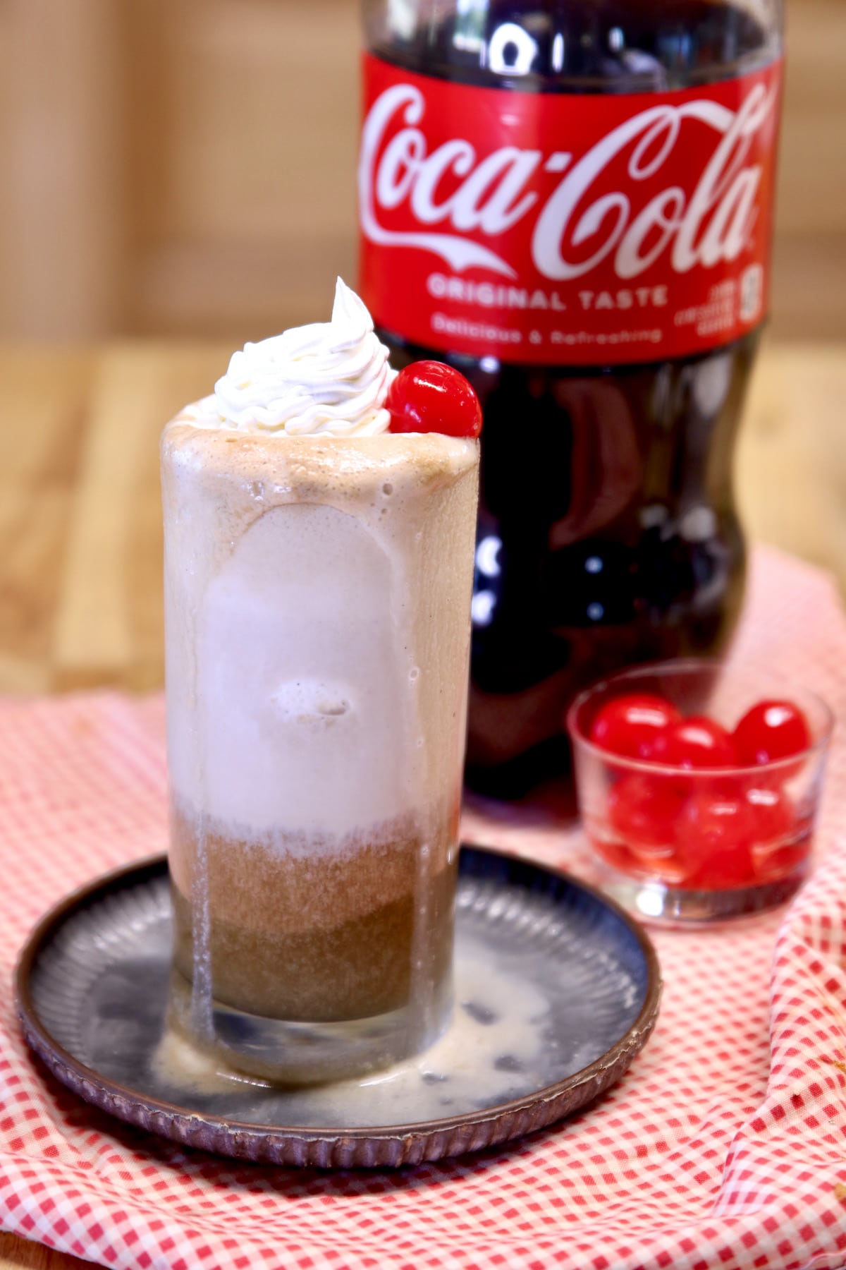 Coke float with rum in a glass, 2 liter bottle of Coca-Cola.