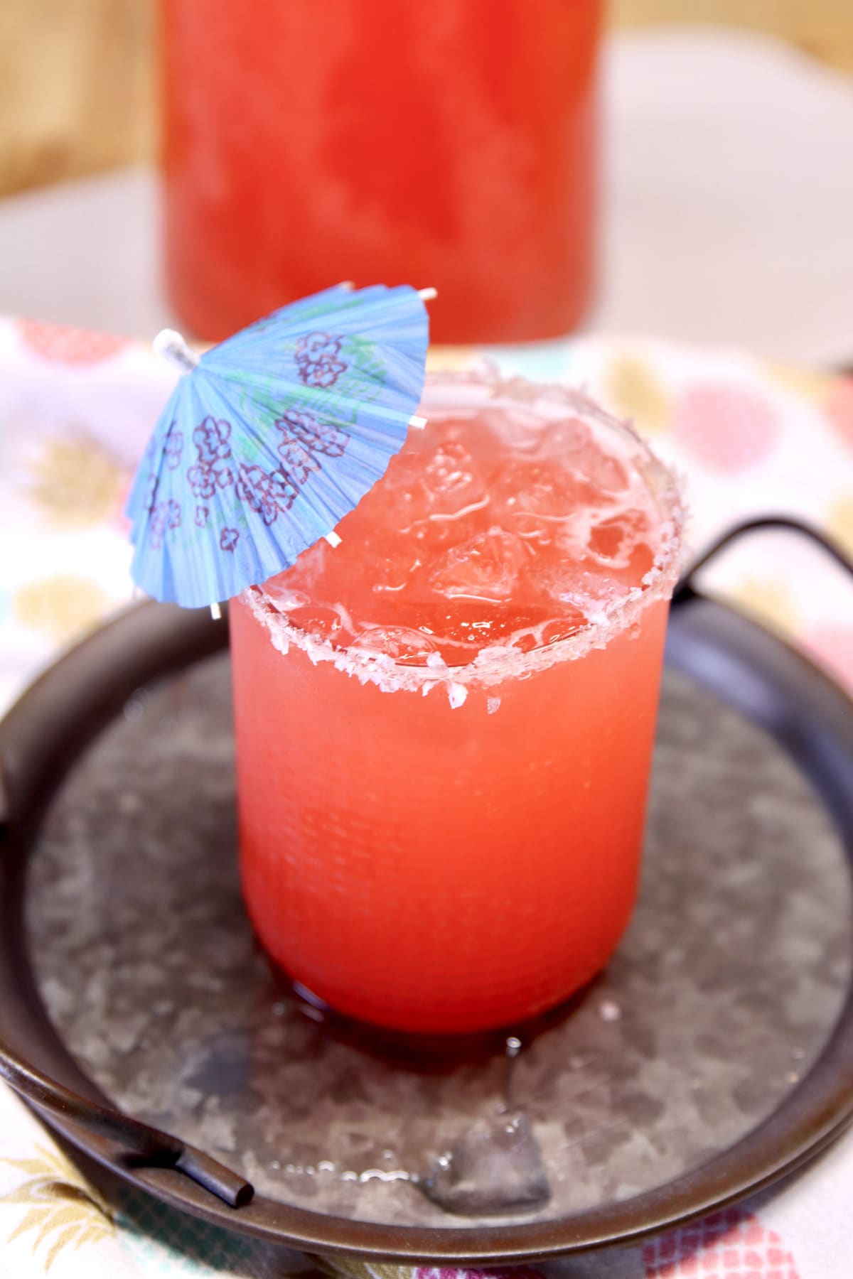 Glass of punch with umbrella.