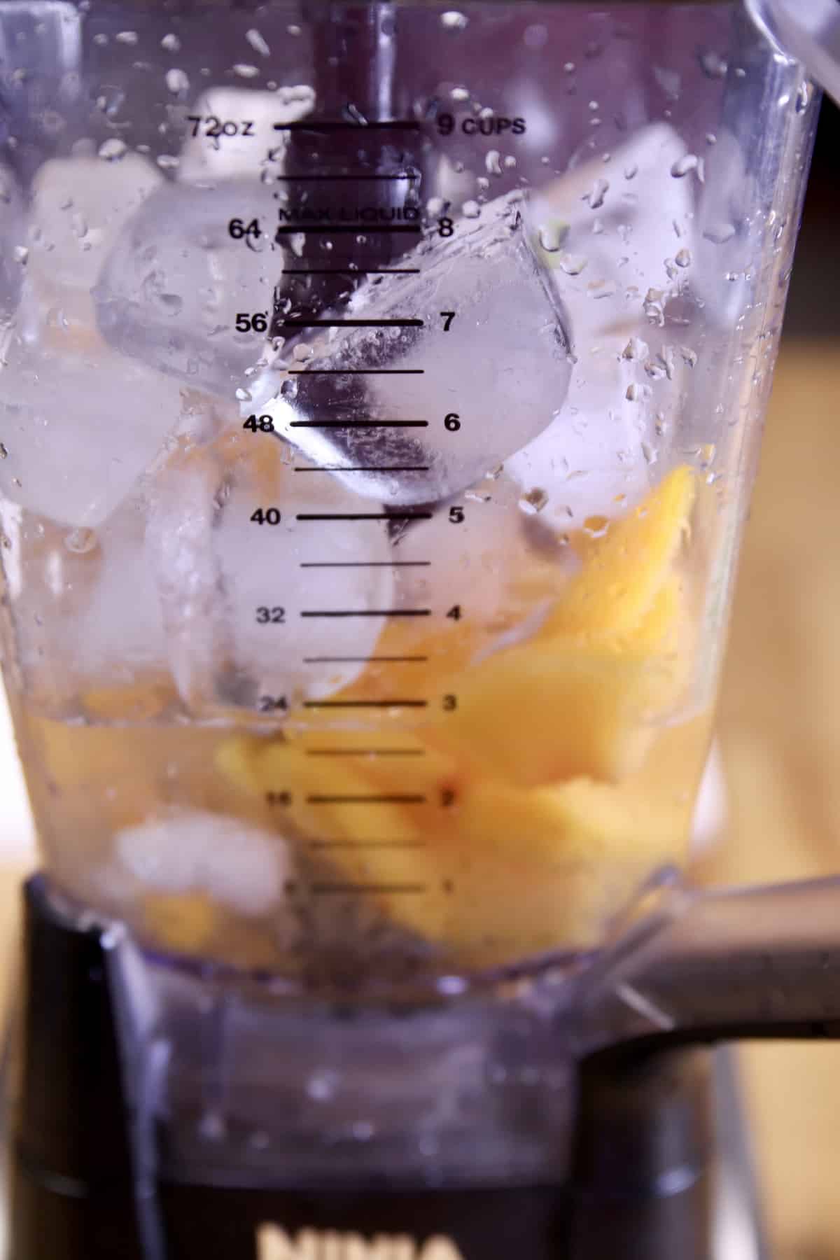 frozen peaches, ice, rum in a blender.