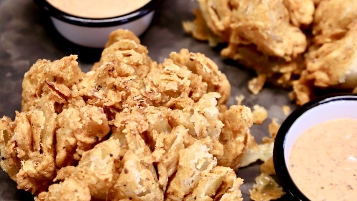 Blooming Onions with sauce on a platter.