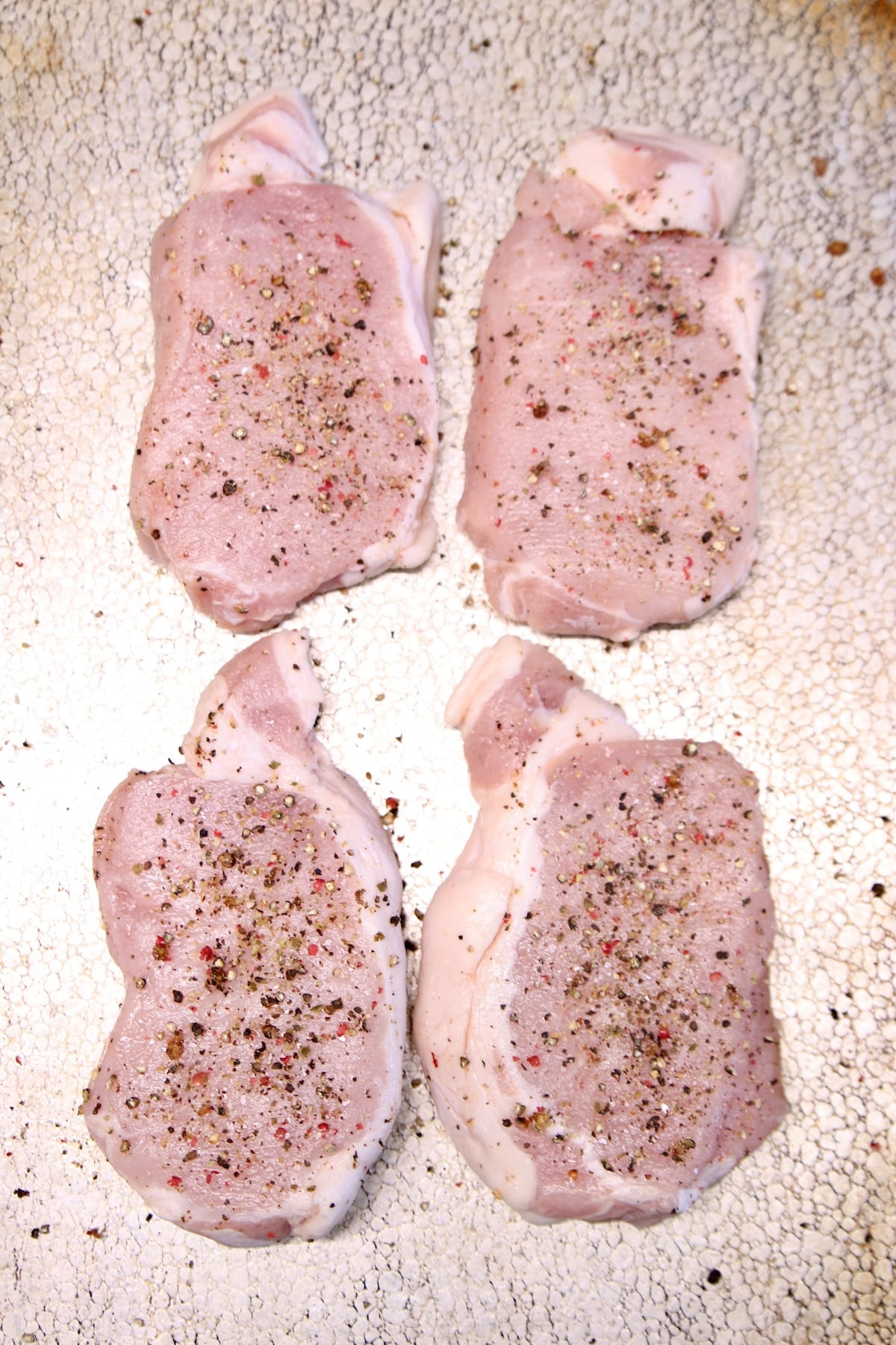 4 boneless pork chops with salt and pepper.