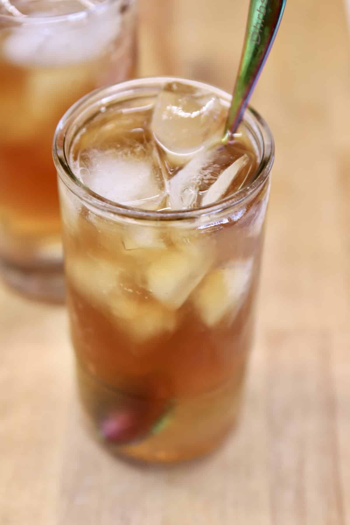 Iced tea in a glass with a spoon.