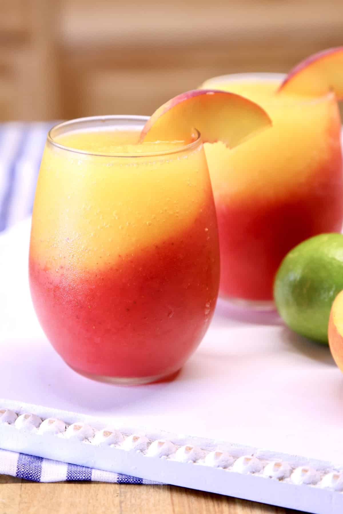 Frozen strawberry and peach layered cocktails.