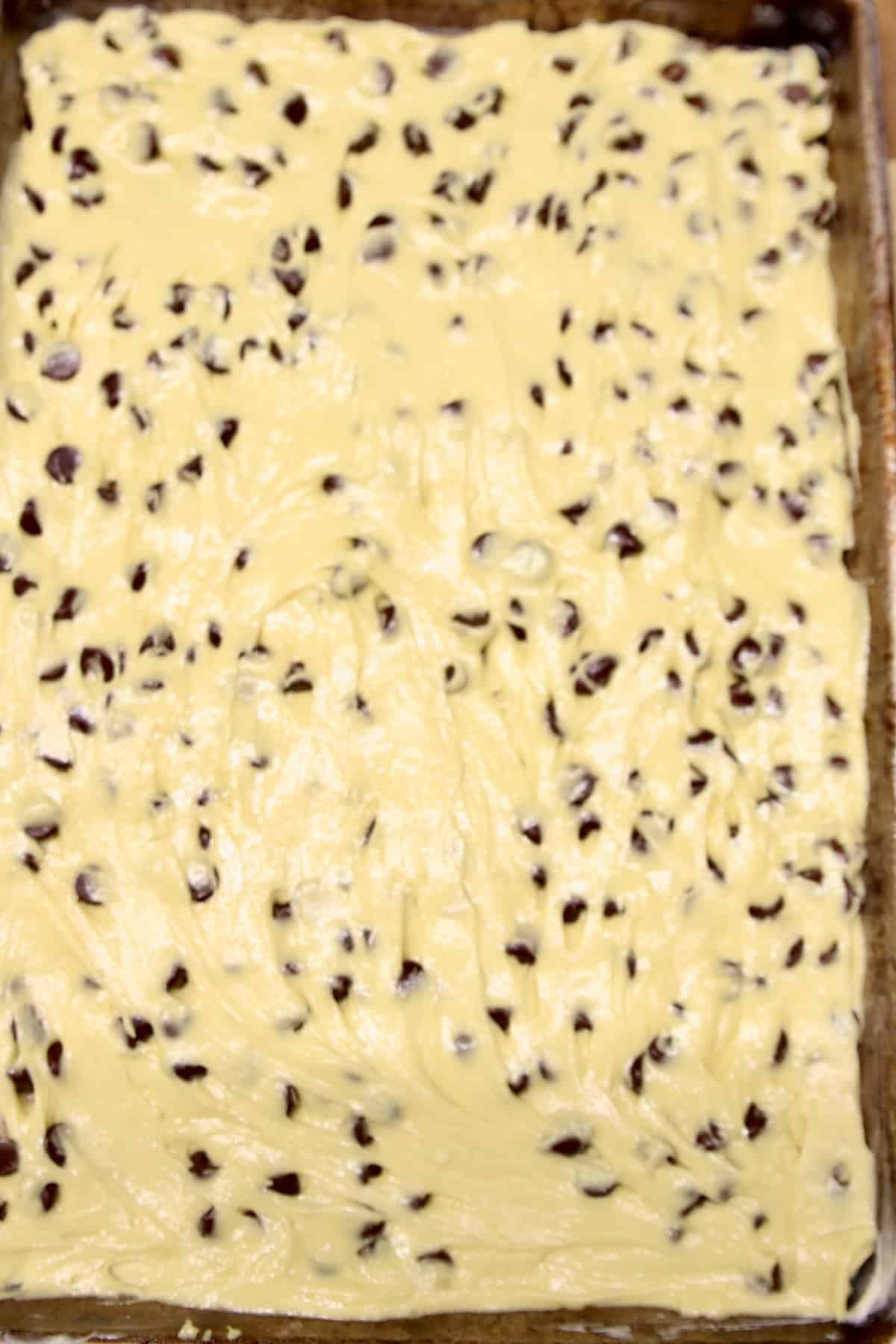 Chocolate chip bars in a pan ready to bake.