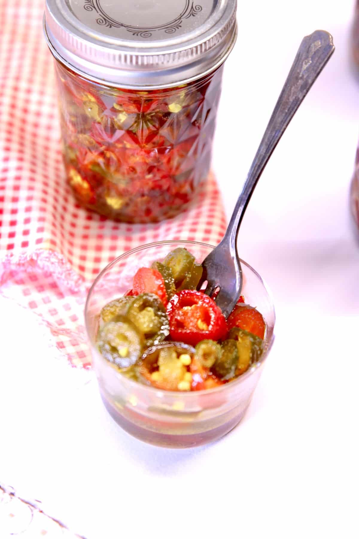 jar and bowl of candied jalapenos.