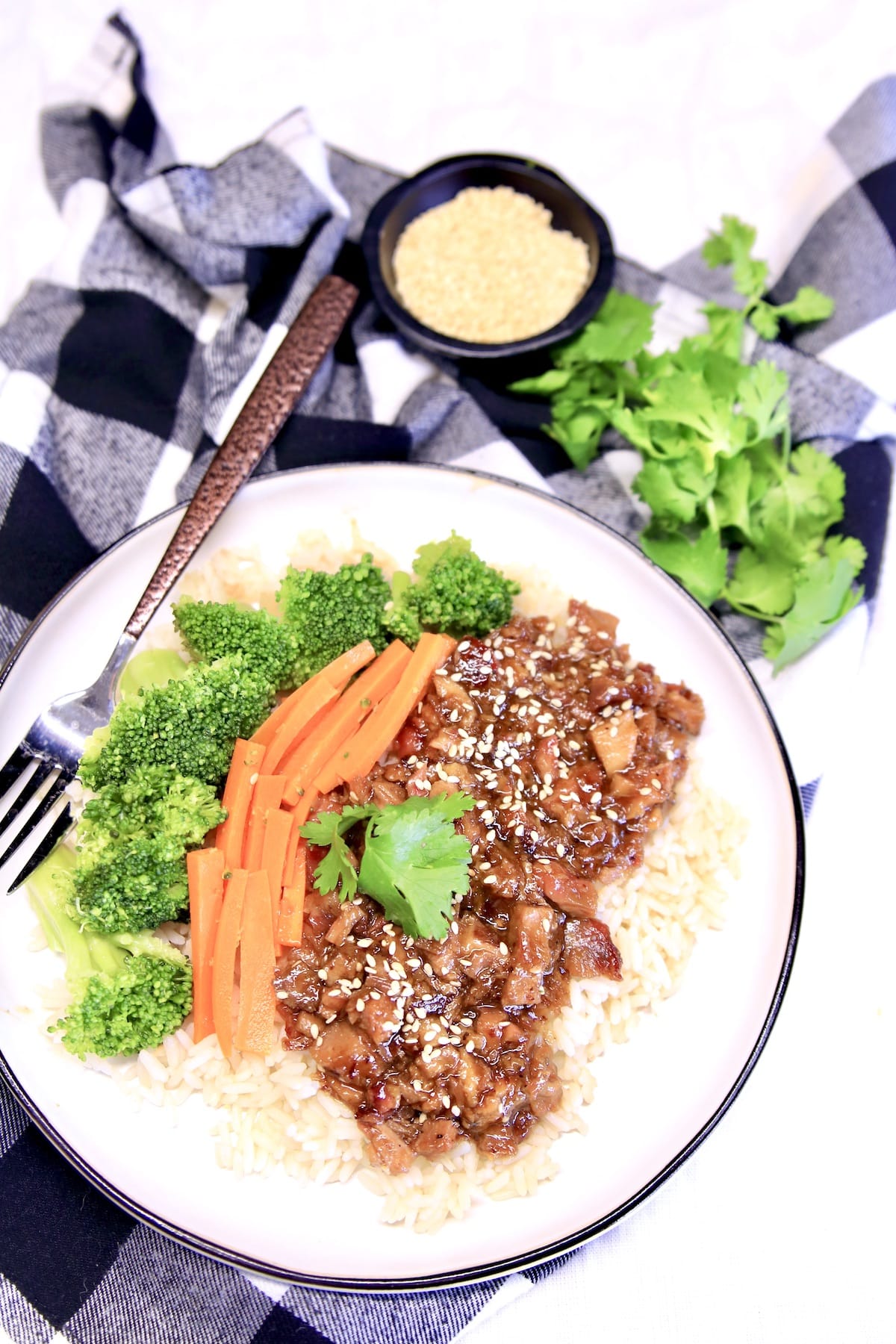 Plate of Mongolian pork with carrots and broccoli over rice.