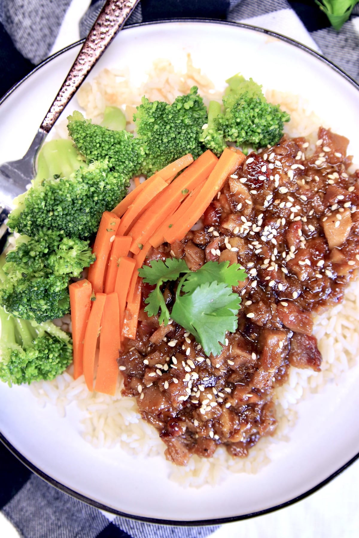 Plate of Mongolian Pork with broccoli and carrots over rice.