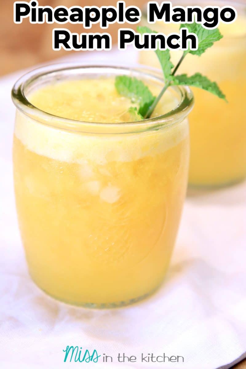 Closeup of pineapple mango punch in a glass - text overlay.