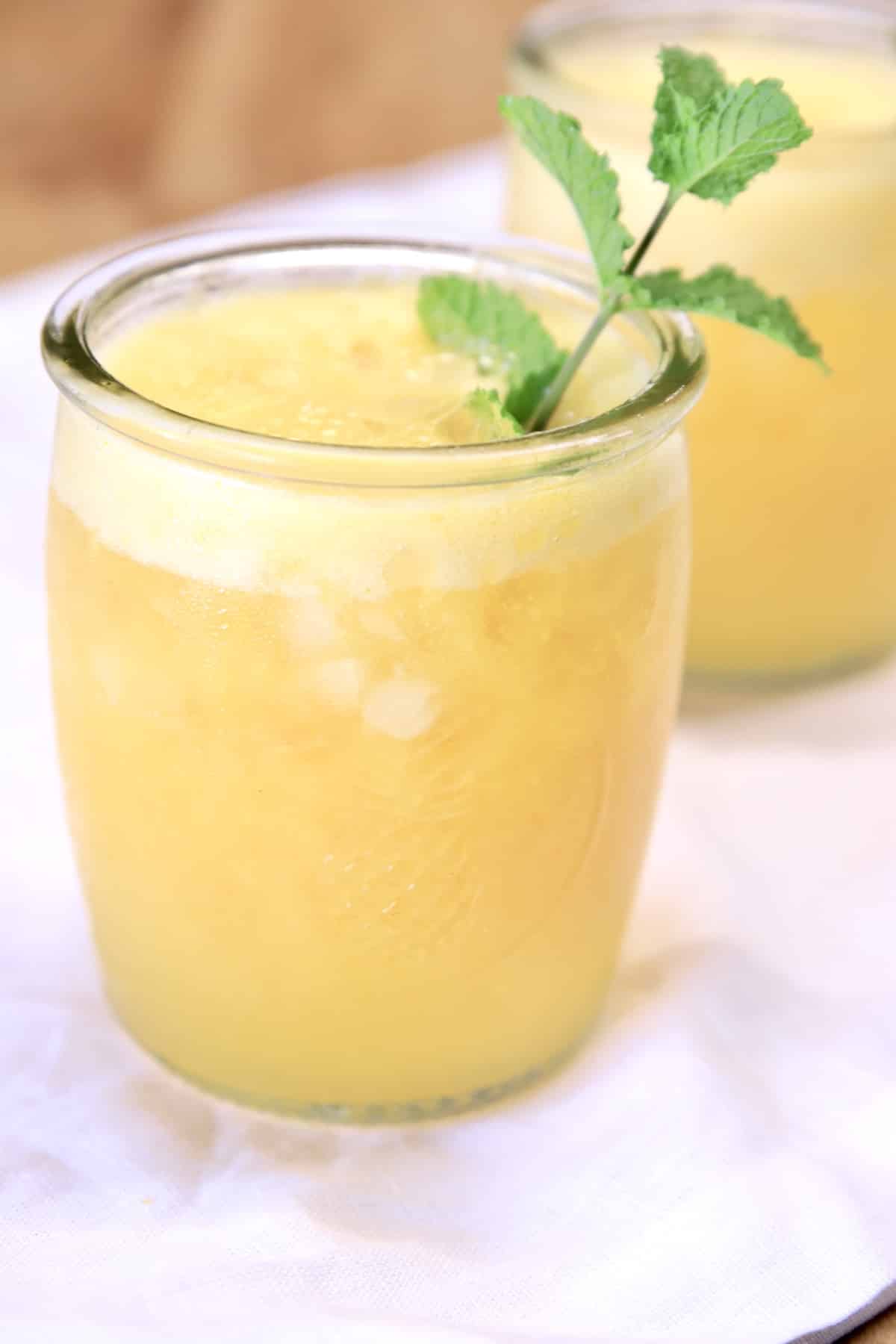 Pineapple Mango Rum Punch with mint garnish.