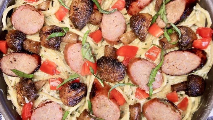 Pasta with smoked sausage and tomatoes.