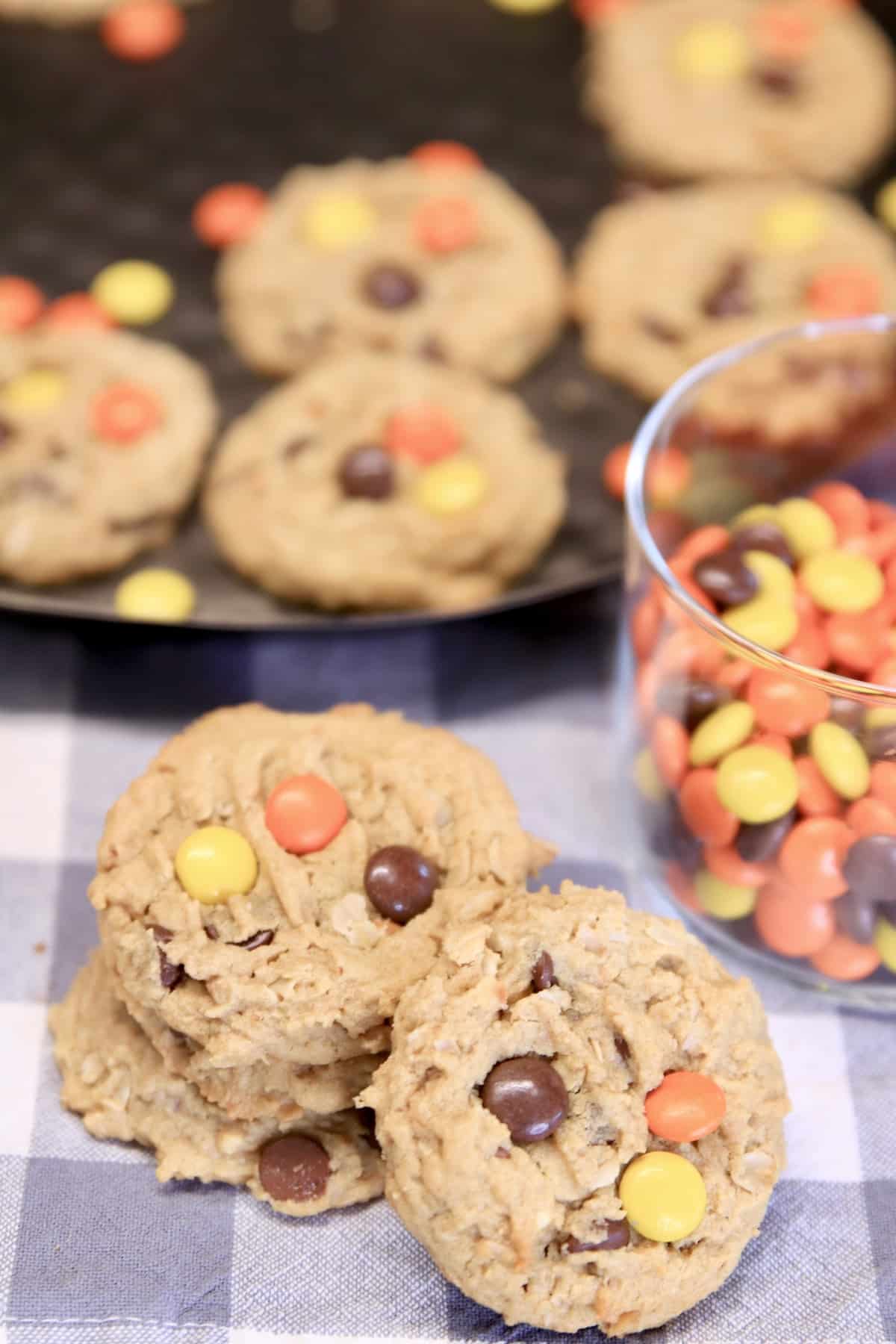 Monster cookies stacked with reese's pieces candies.