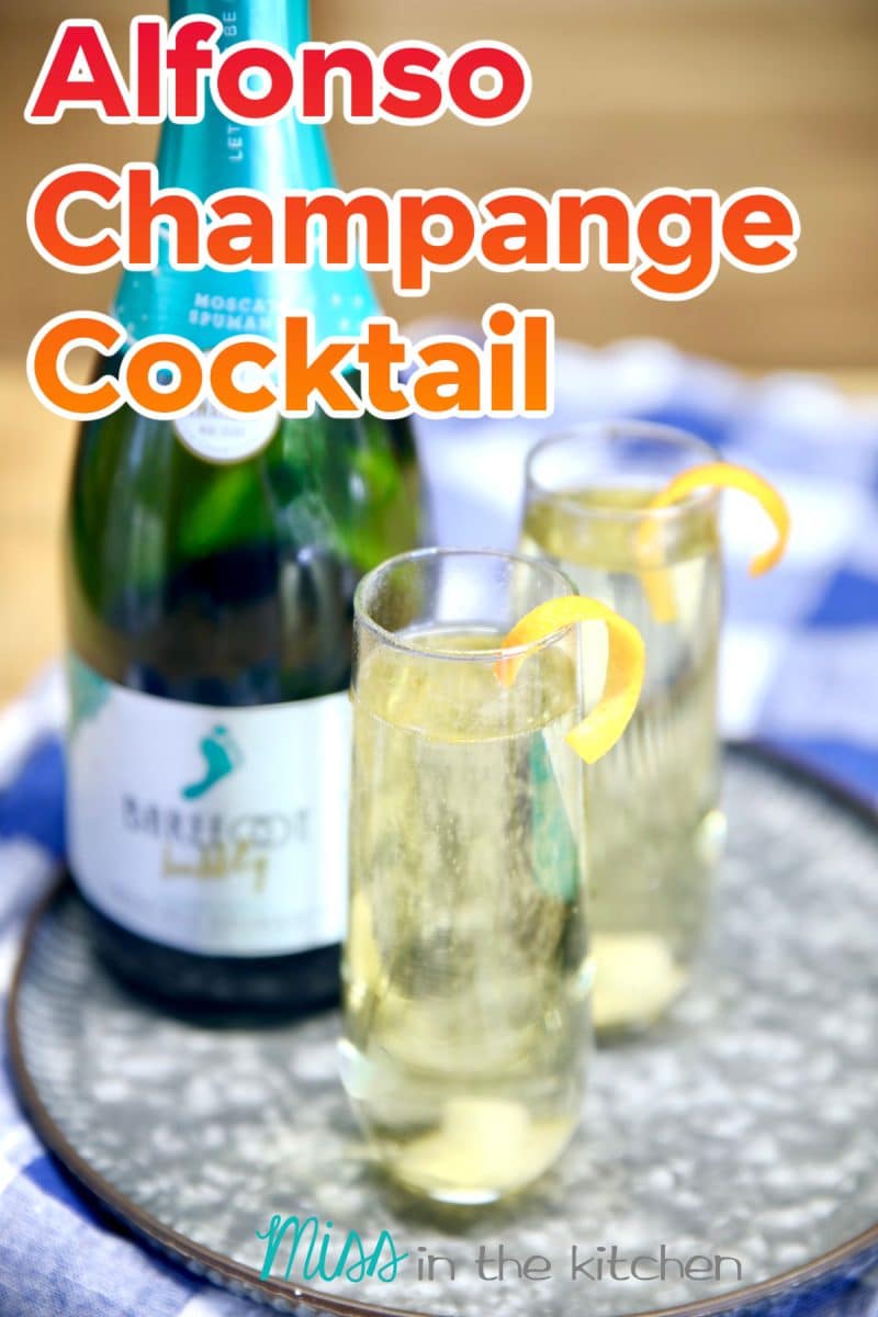 Alfonso Champagne Cocktail on a tray. Text overlay.