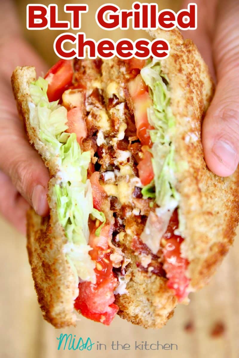 BLT Grilled Cheese sandwich, cut in half, held in hands.