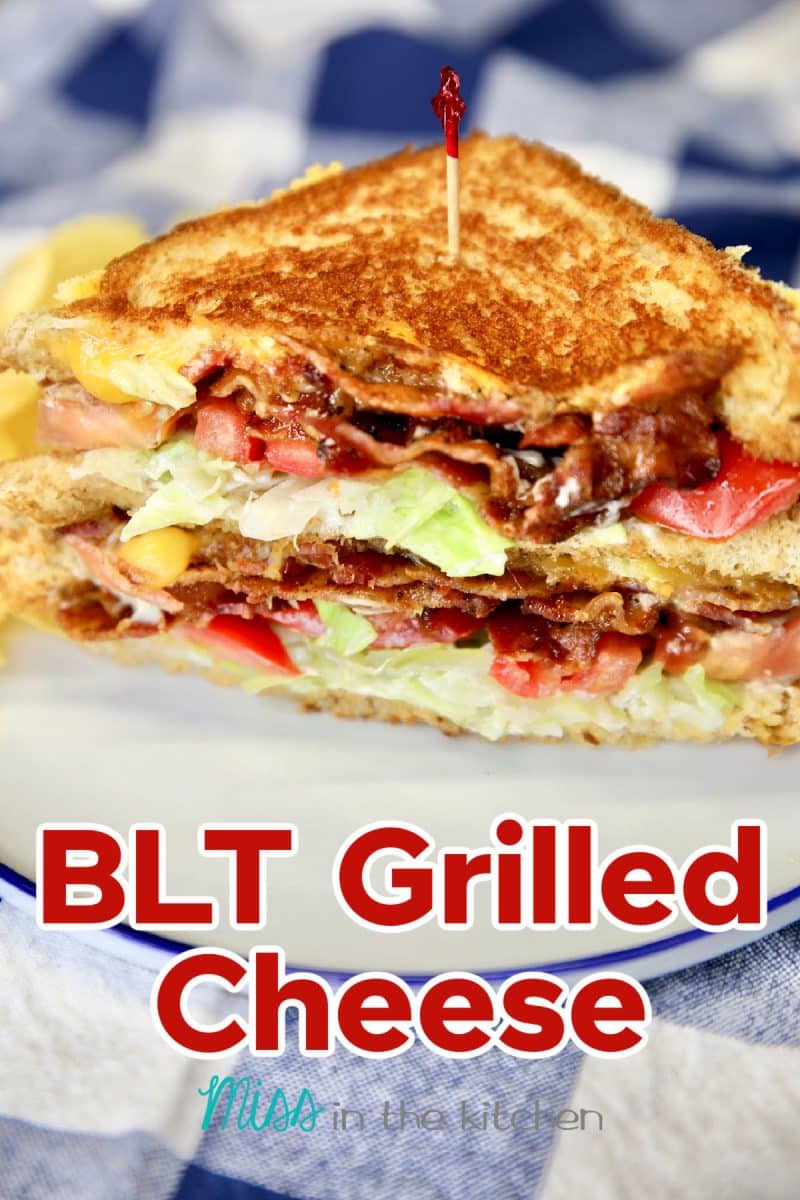 BLT Grilled Cheese on a plate, cut in half.