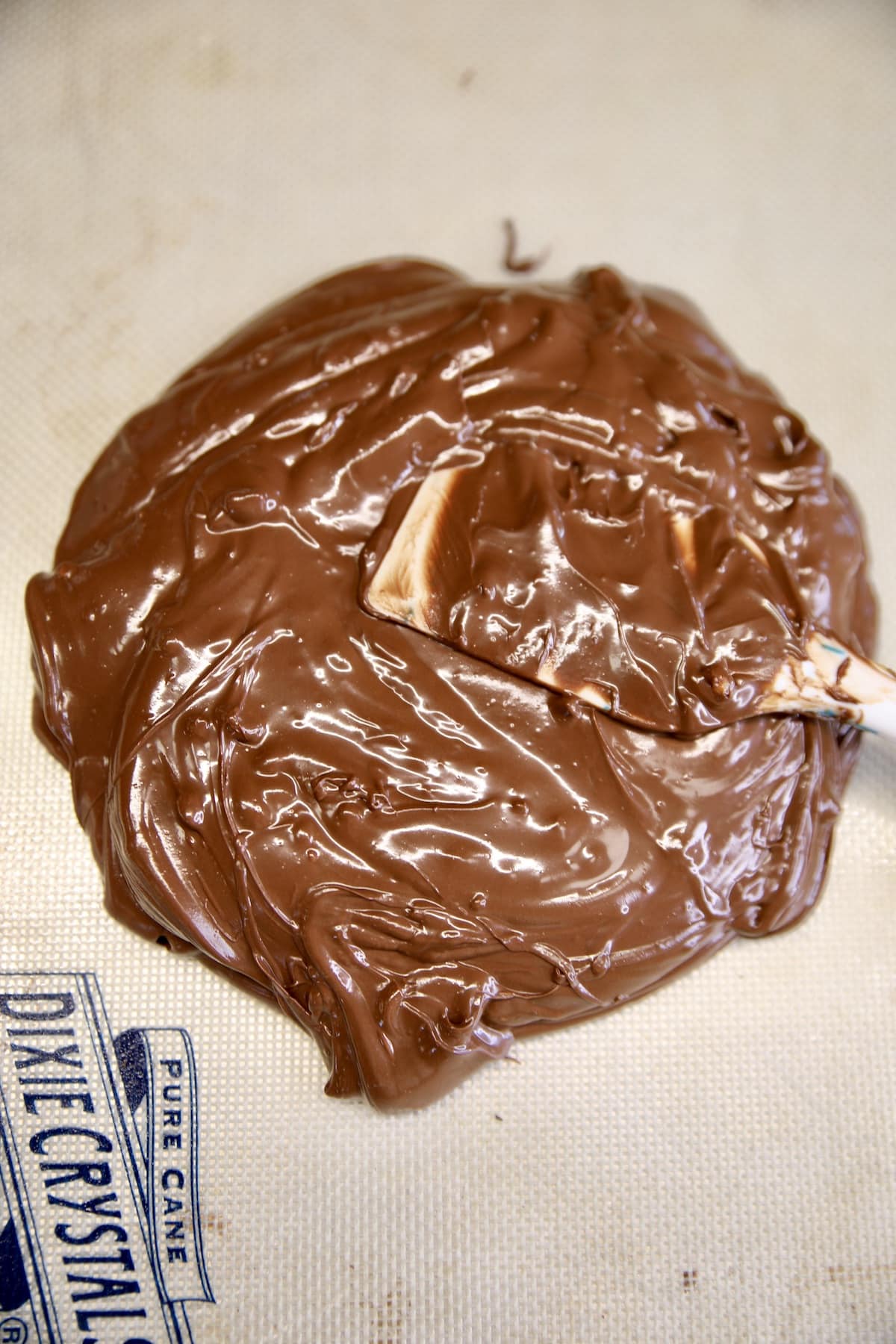 Melted chocolate on a silicone mat.