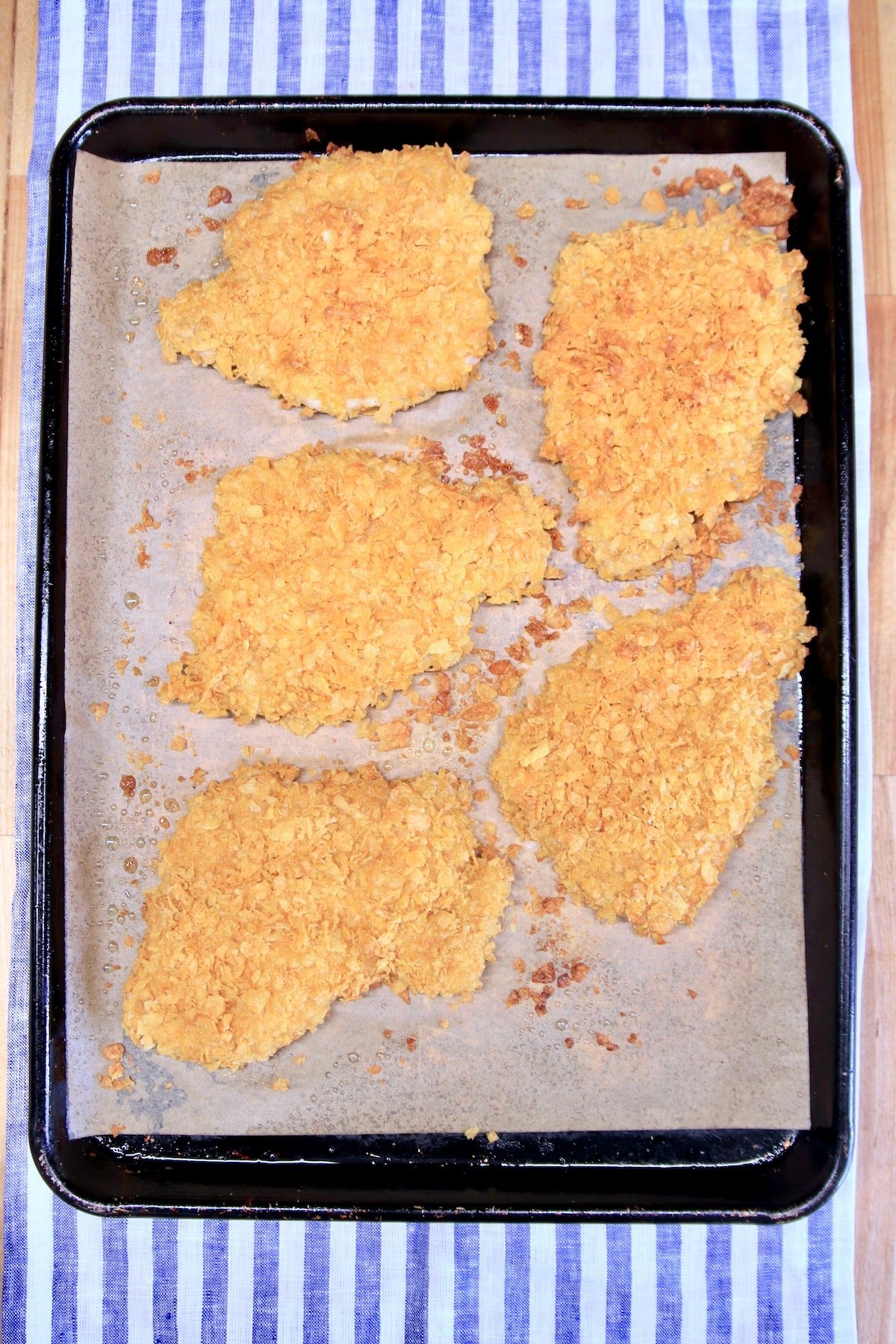 Baked cornflake pork chops on a sheet pan.