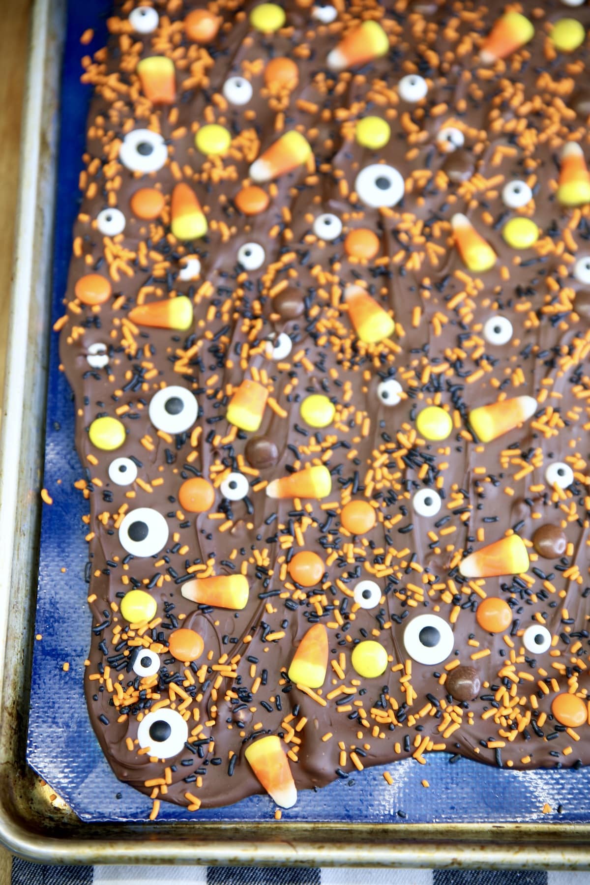 Halloween Bark with candy on a sheet pan.