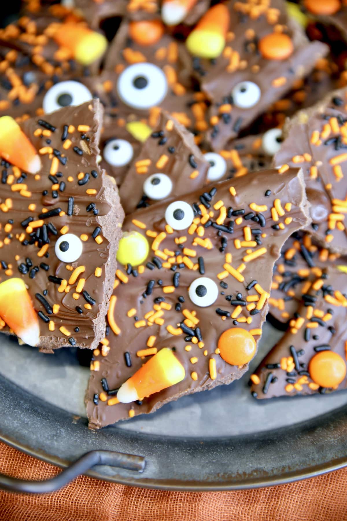 Halloween Bark with candy and sprinkles on a platter.