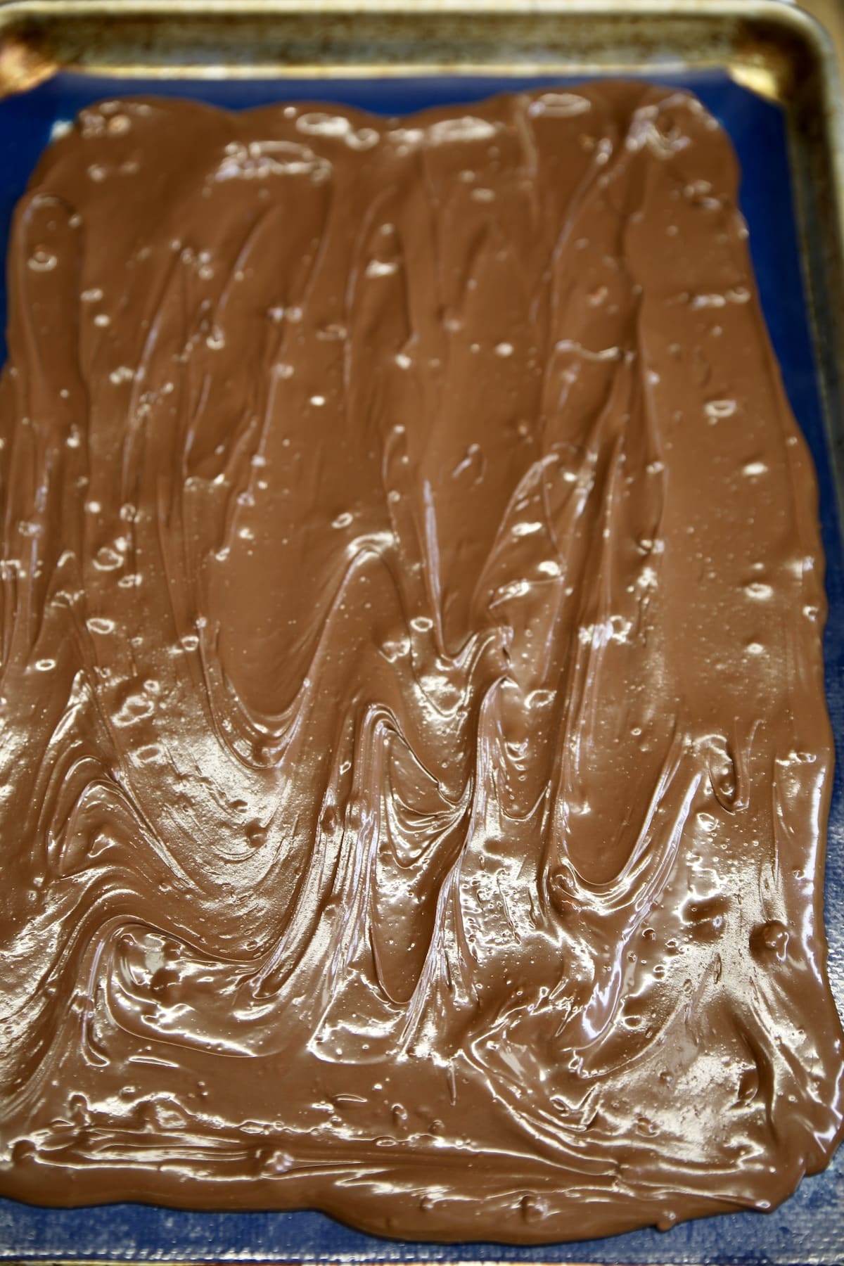 Chocolate bark on a baking sheet.