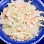 Blue bowl with homemade coleslaw with creamy dressing.