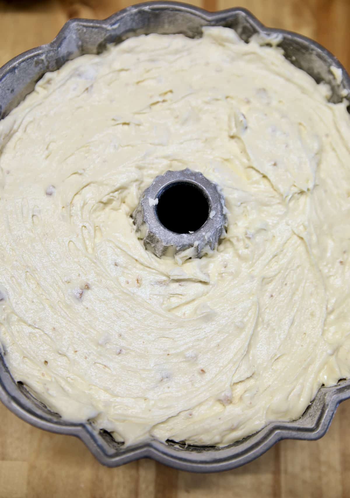 Pecan pound cake batter in bundt pan.
