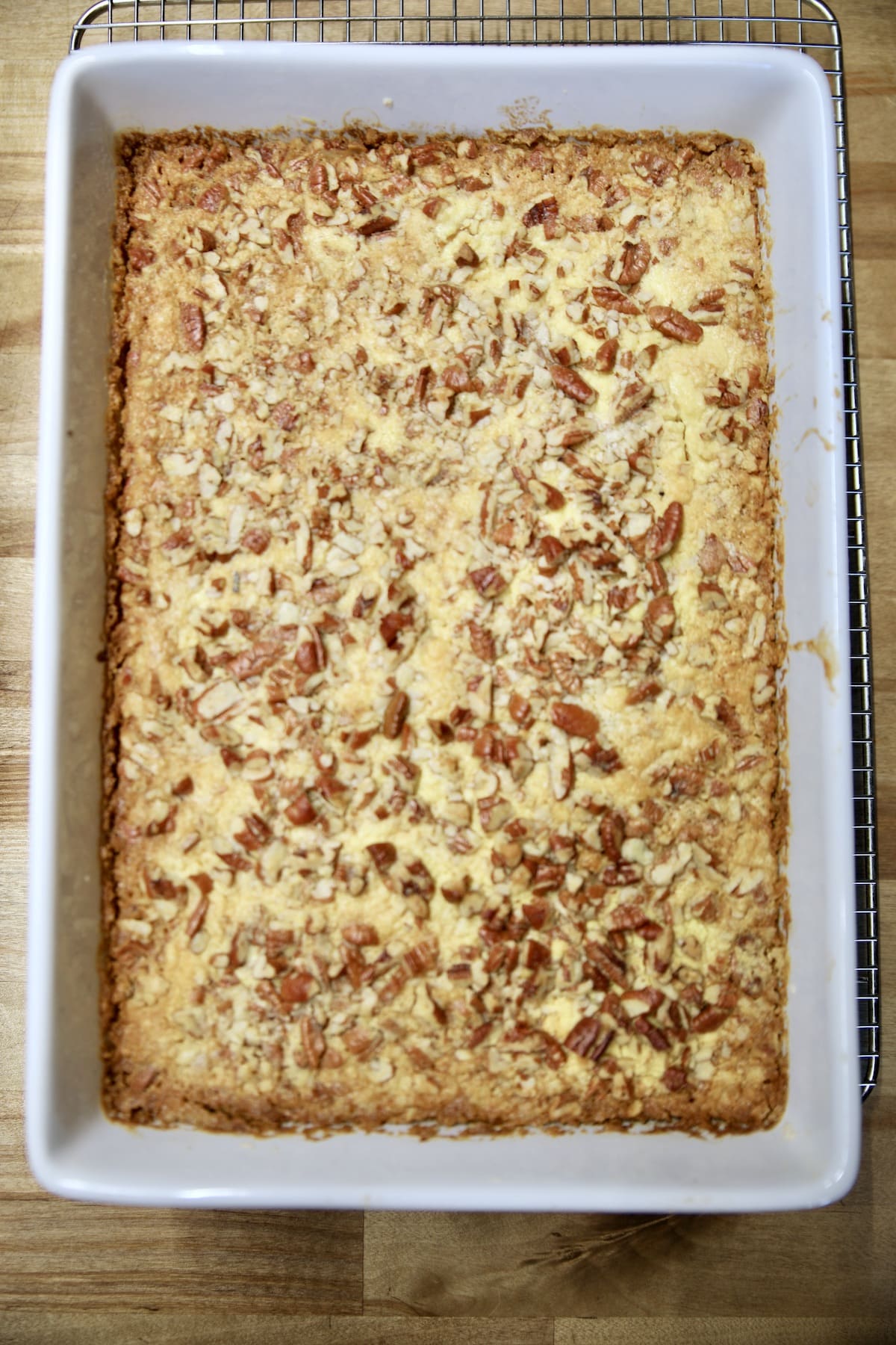 Baked pumpkin pie cake with pecans in a 9 x 13 inch pan.