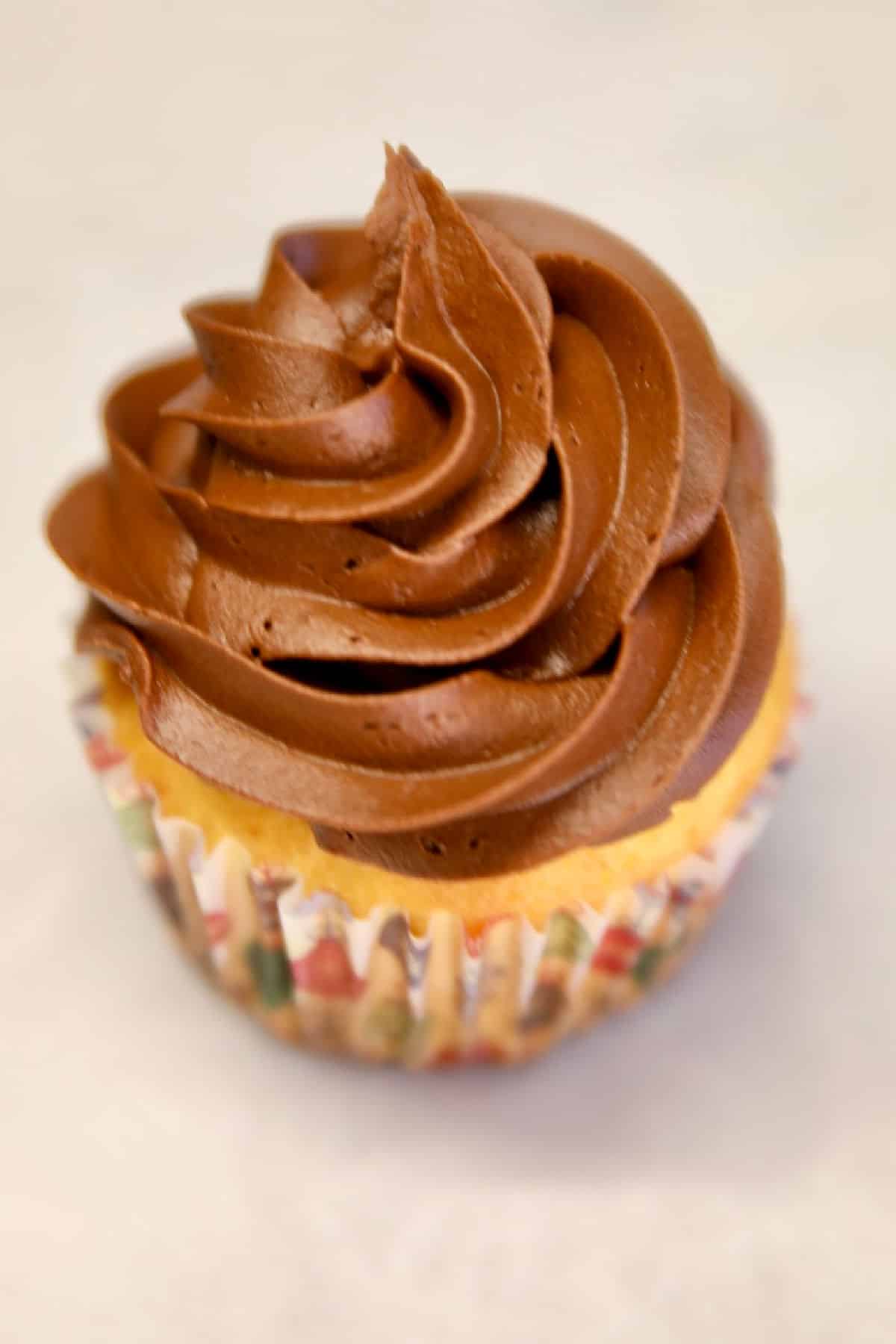 Chocolate frosted cupcake.