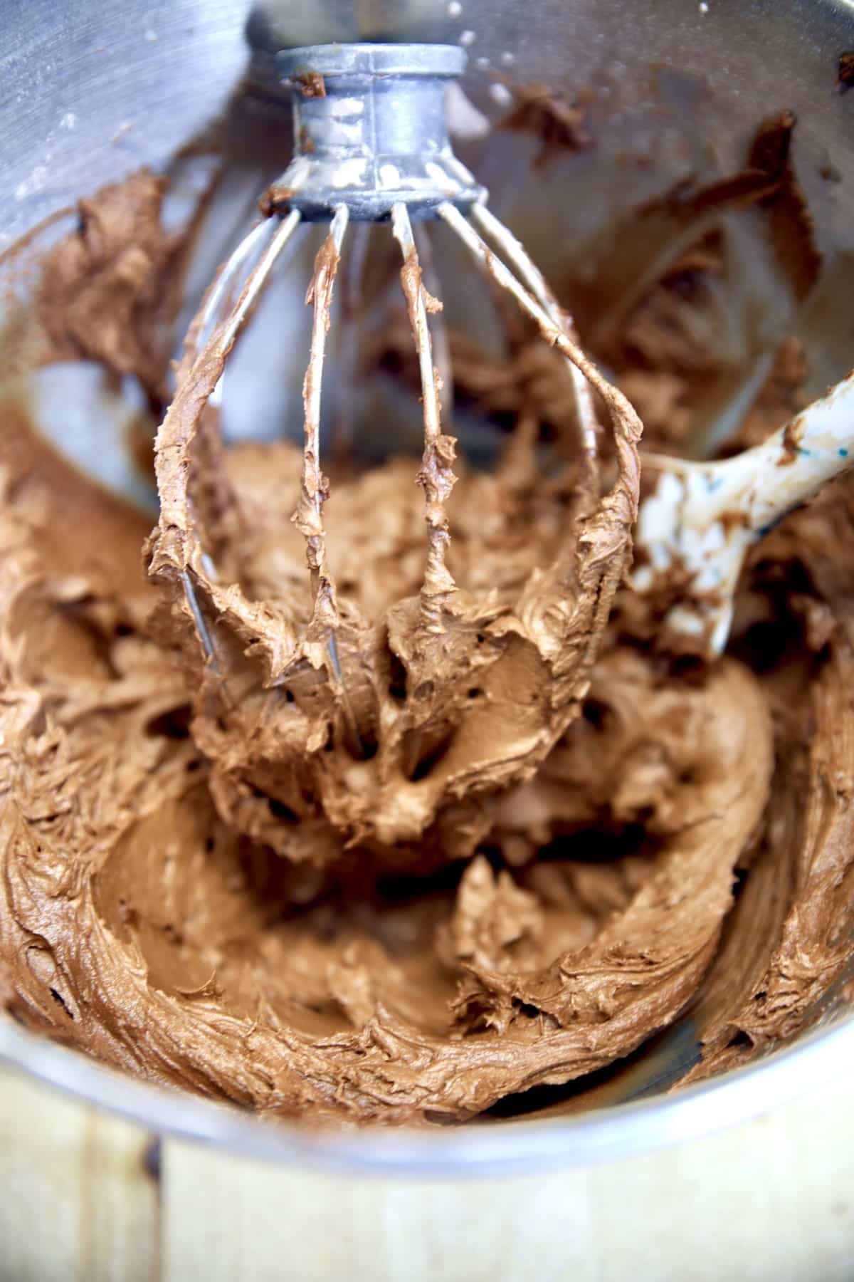 Chocolate Frosting on a mixer whisk.