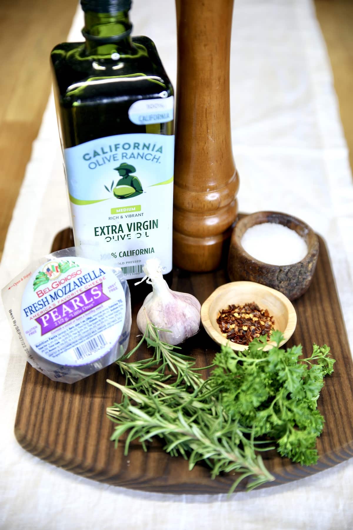 Ingredients for olive oil marinated mozzarella balls.
