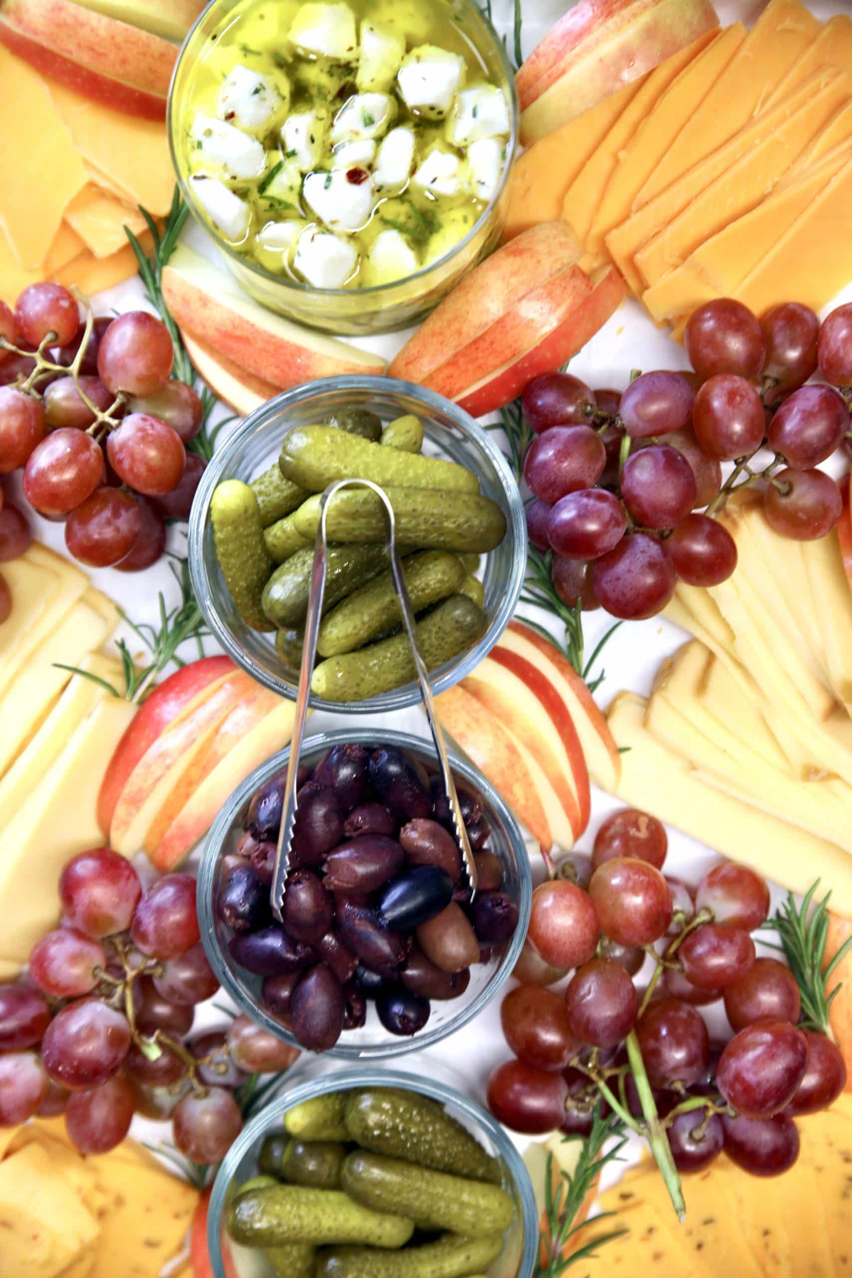 Closeup of cheeseboard with fruit and nuts.