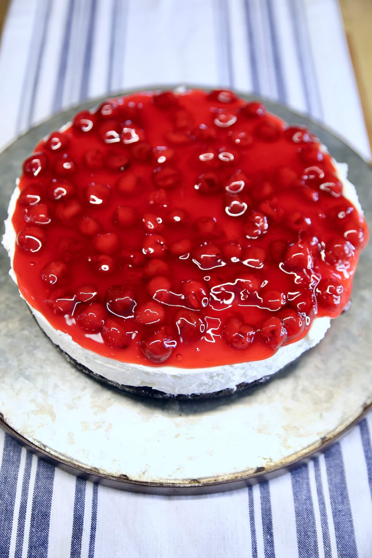 Cherry cheesecake on a platter.