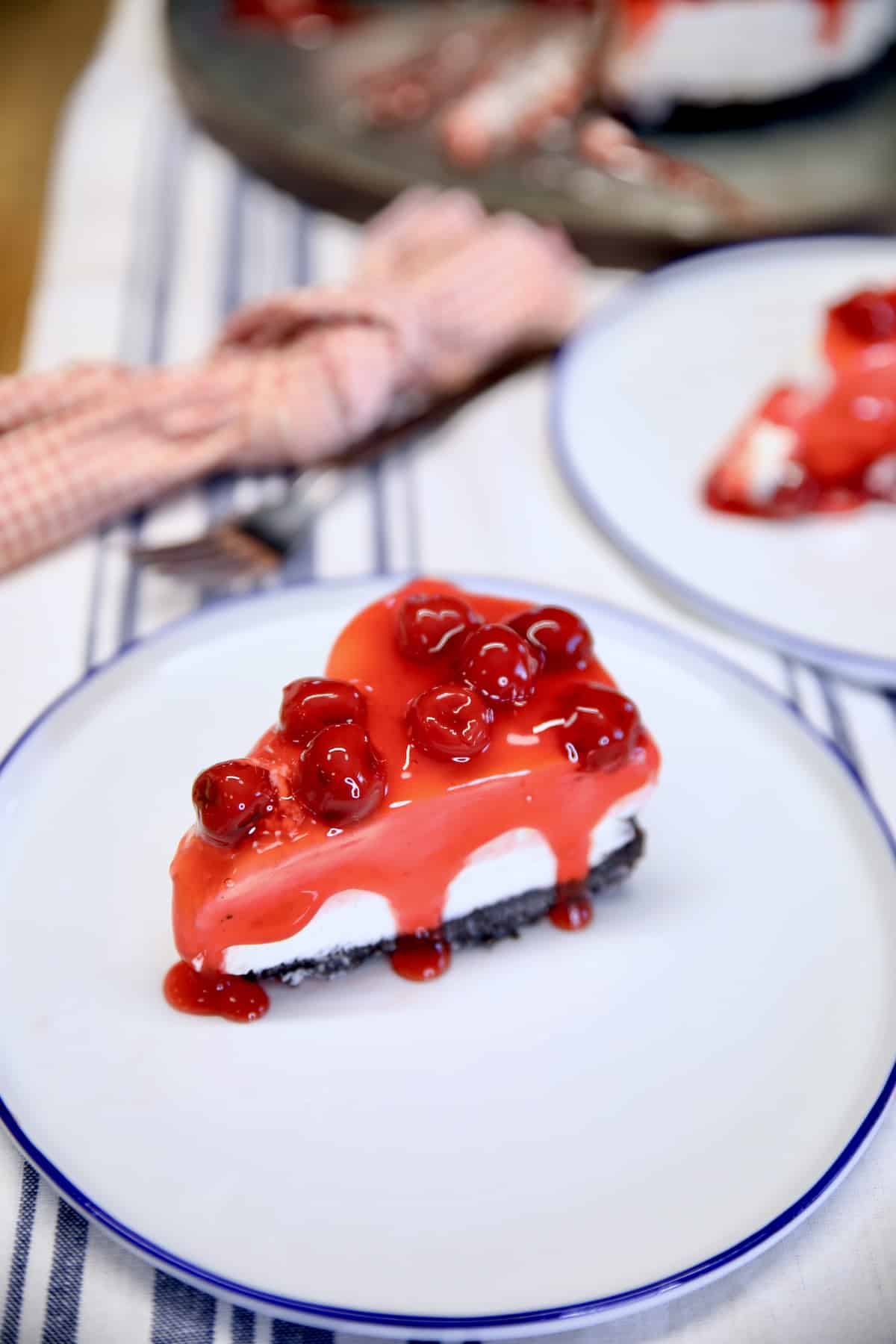 Slice of cherry cheesecake on a plate.