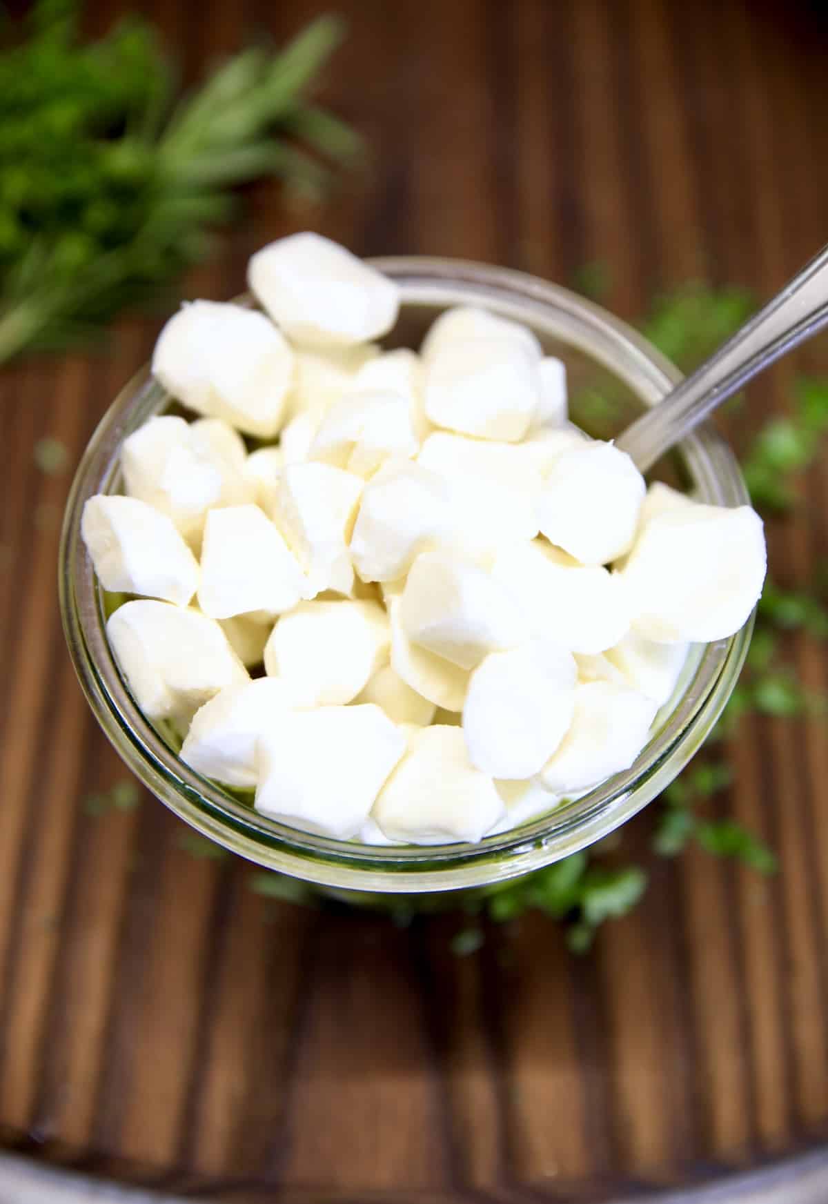 Mozzarella pearls in a jar with olive oil marinade.