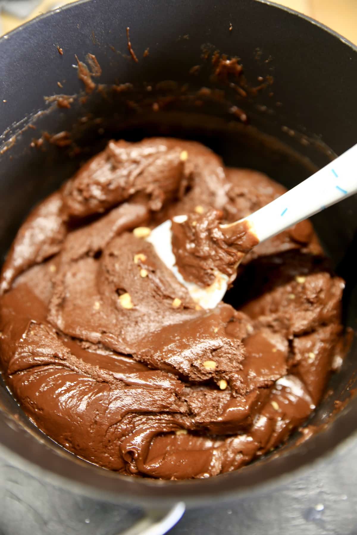 Chocolate fudge in a pan with spatula.