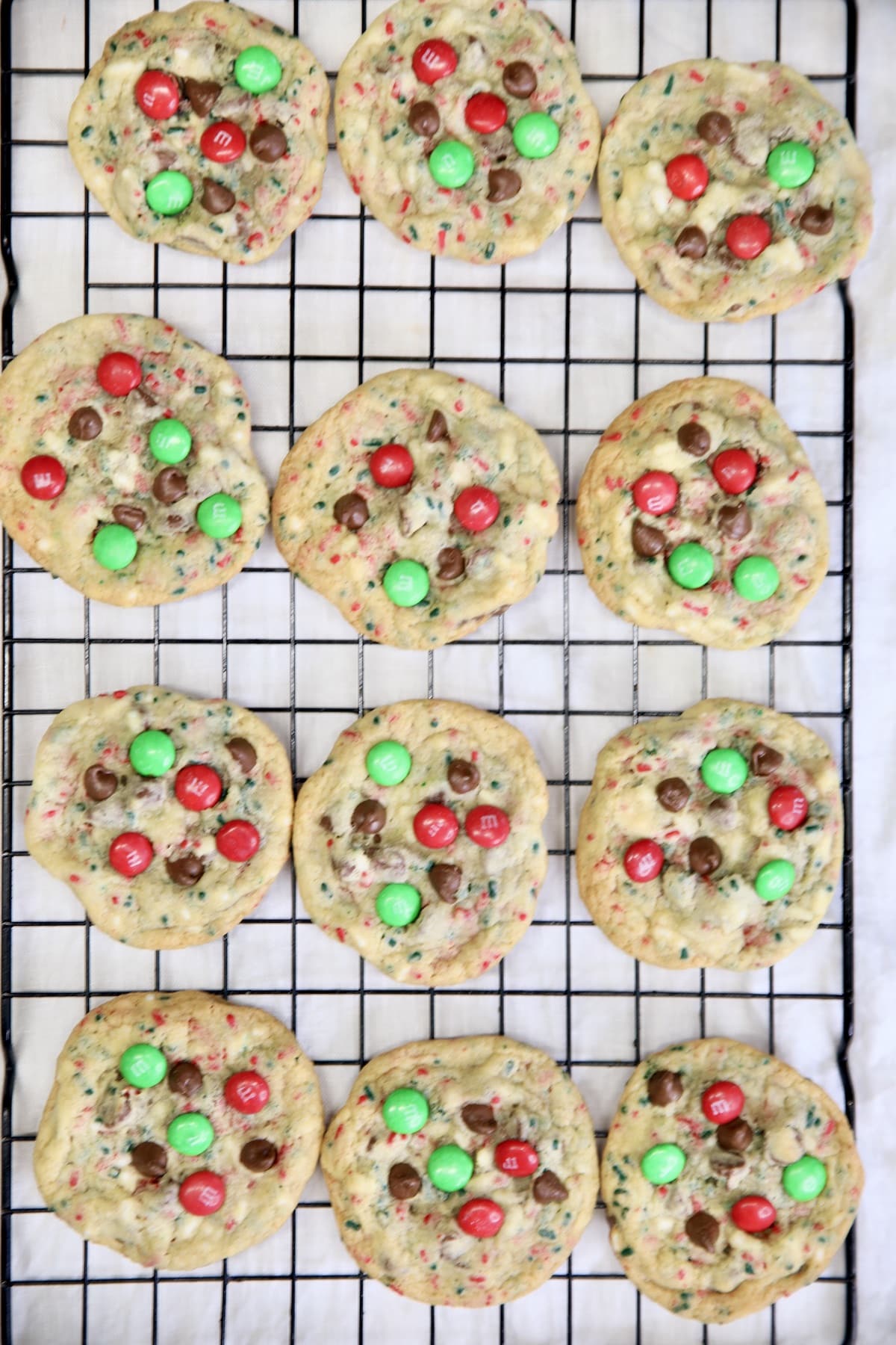 Wire rack of chocolate chip M&M cookies.