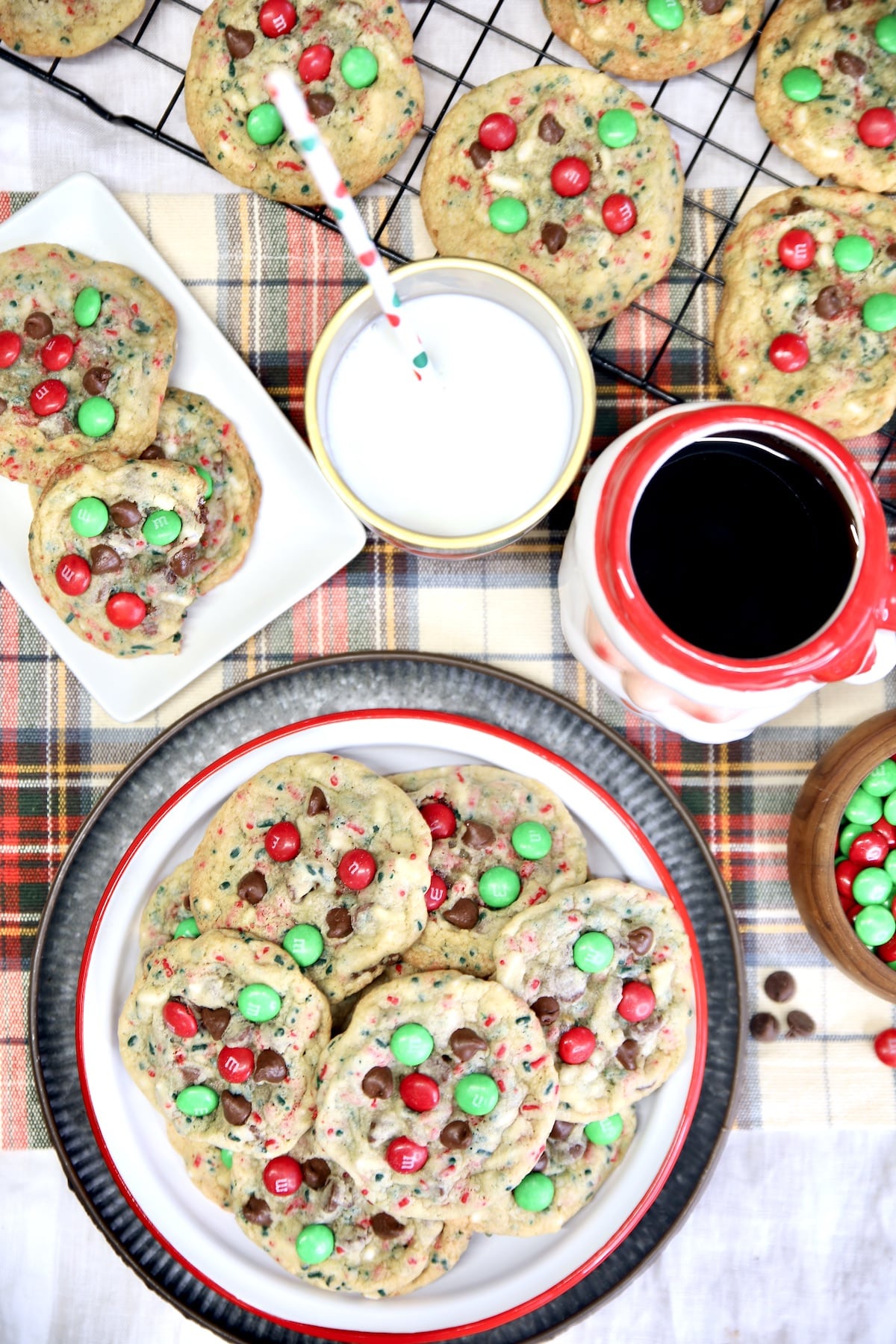 Overhead view of Christmas M&M cookies with milk, coffee.