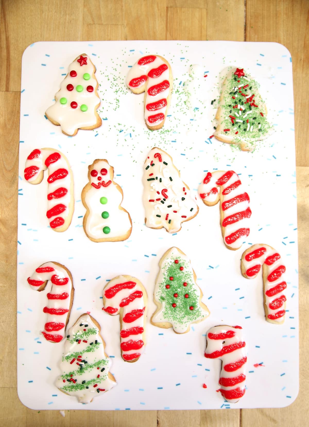 Decorated sugar cookies for Christmas on a white surface.