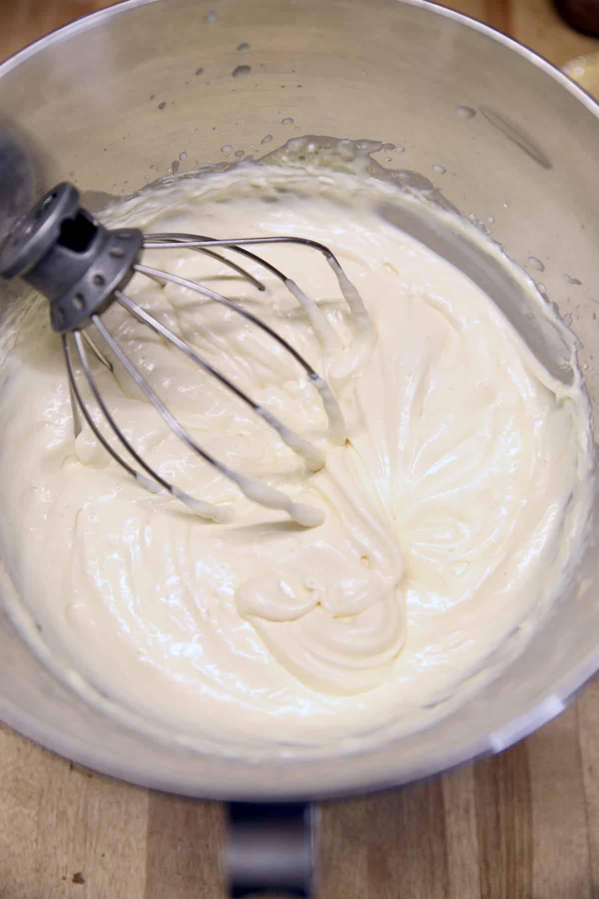 Bowl with no bake cheesecake filling and whisk attachment.