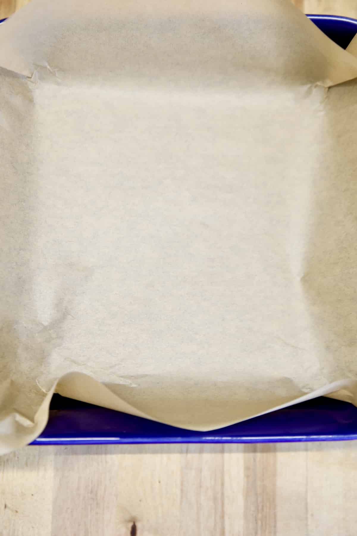 Square pan lined with parchment paper.