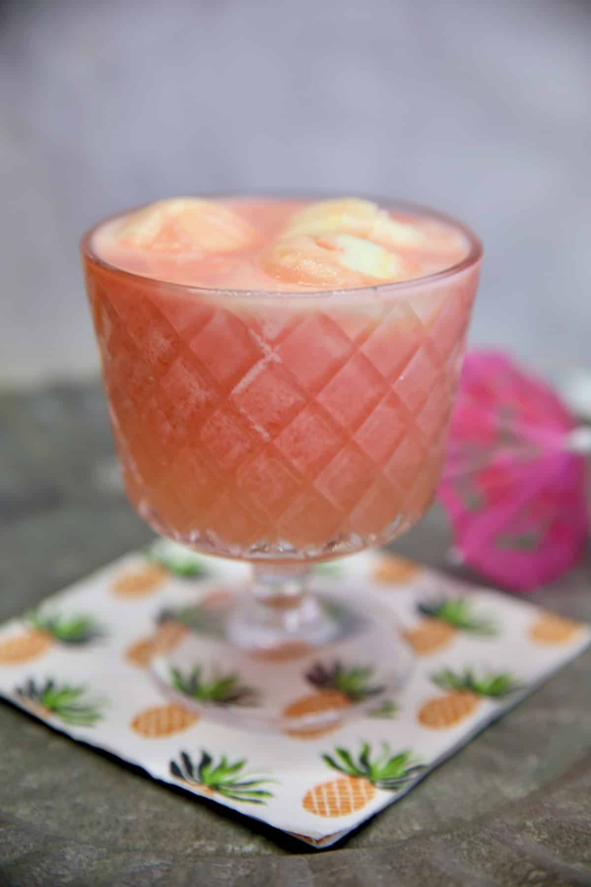 Sherbet punch in a glass with pineapple sherbet on top.