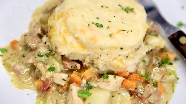 Chicken and biscuits casserole on a plate with a fork.