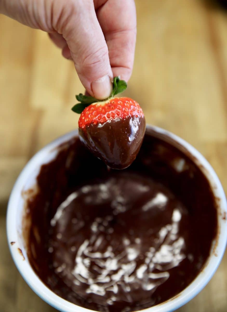 Dipping strawberries in chocolate ganache.