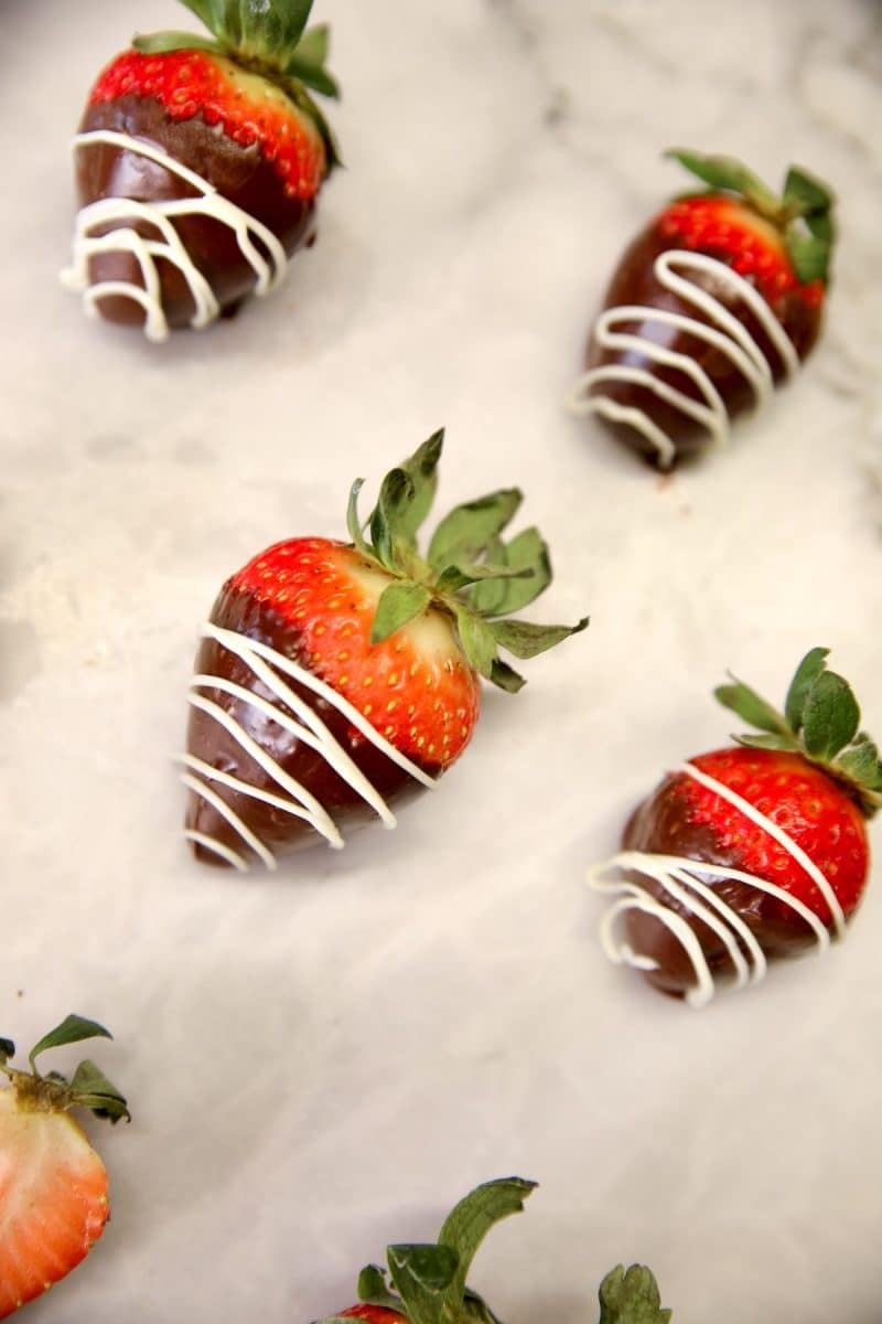 Chocolate covered strawberries on white marble.