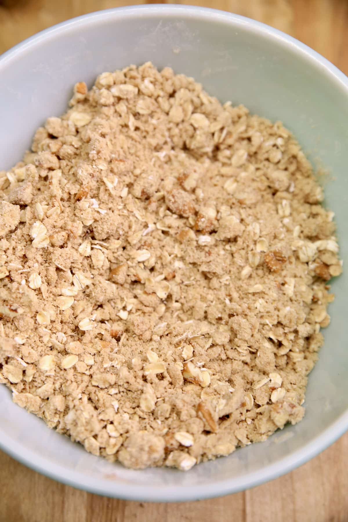 Oat and brown sugar topping for fruit crisp in a bowl.