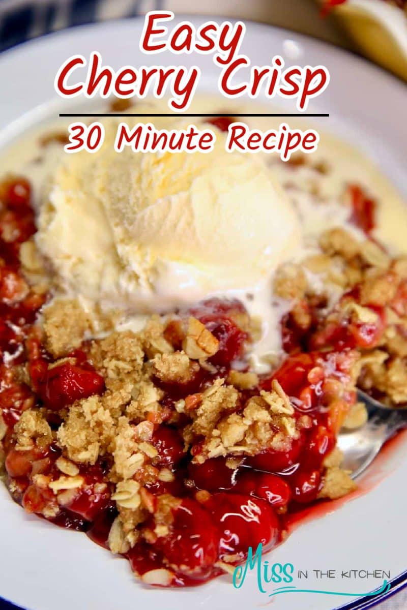 Plate with cherry crisp topped with vanilla ice cream - text overlay.