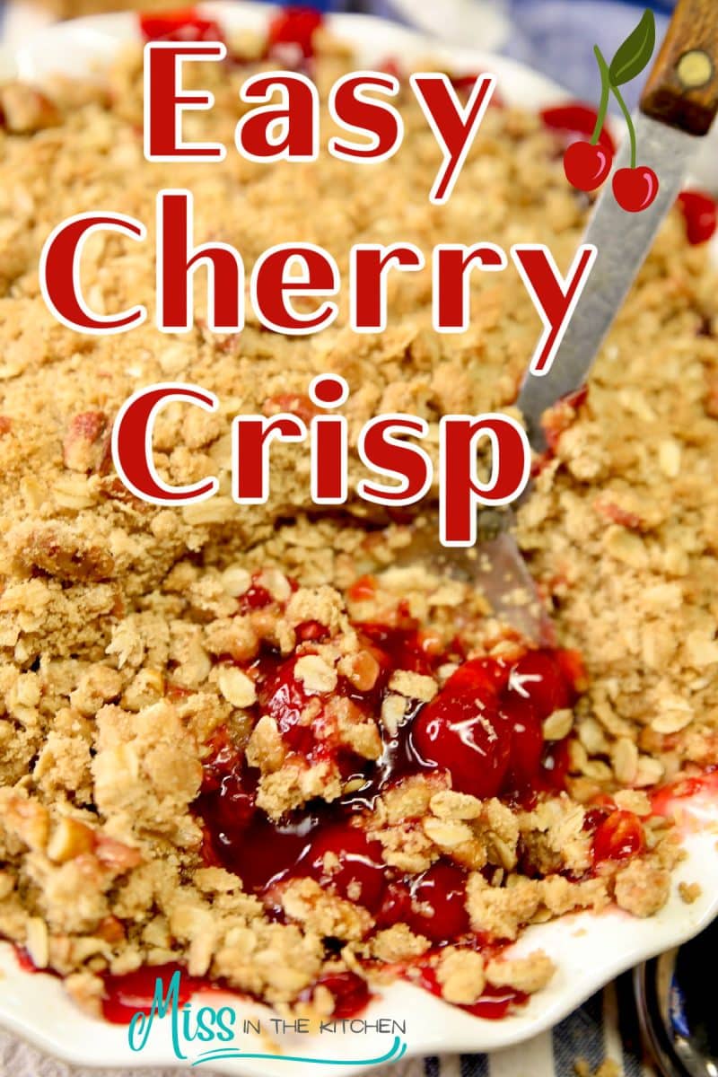 Cherry crisp in a pie plate with spoon scooping - text overlay.